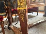 a table that has a clock on it in the middle of the room