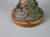 a statue of a woman sitting on a table