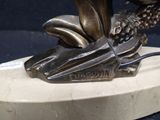 a statue of a bird on a marble base