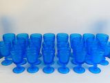 a lot of blue glass vases and glasses on the table