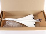 a model of a plane in a box on a white surface