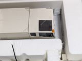a microwave oven sitting on top of a white refrigerator