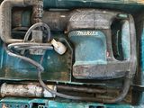 une boîte bleue contenant une perceuse et un cordon d'alimentation