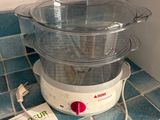 a cookbook on the counter next to a food processor