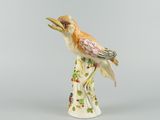 porcelain figurine of a bird perched on a tree branch
