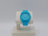 blue and white watch on a white stand on a white surface