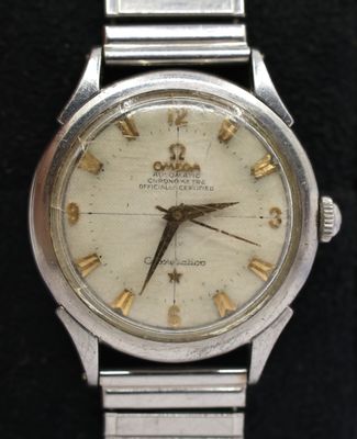 a silver watch with roman numerals on the face