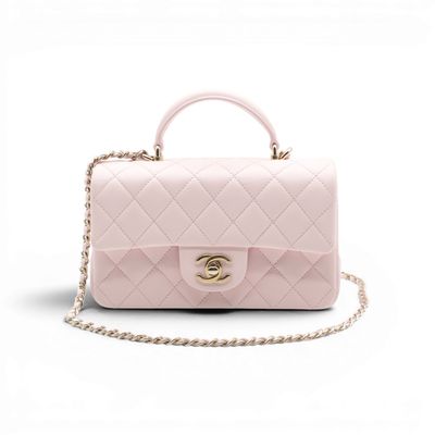 a pink chanel bag on a white background