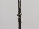 a close up of a clarinet on a stand against a white background