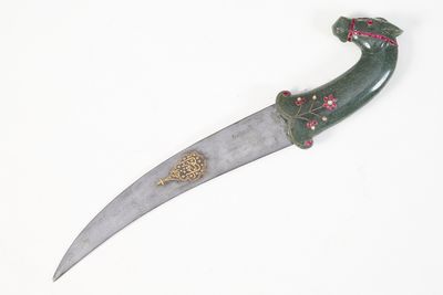 a knife that is on display on a white surface