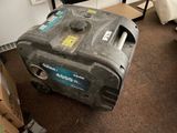 a small portable generator sitting on the floor in a room