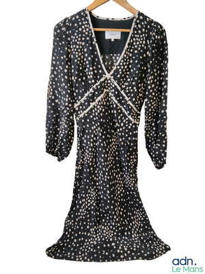an image of a black and white polka dot dress on a hanger