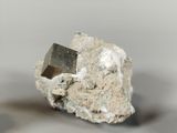 a piece of rock with a small piece of silver on top of it
