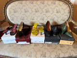 several pairs of women ' s shoes sitting on top of boxes on a chair