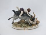 a figurine of a woman riding a bull