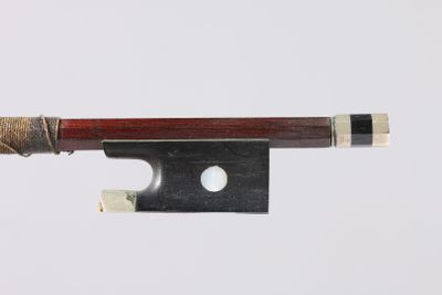 a violin bow with a piece of wood sticking out of it