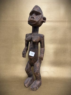 a wooden statue of a person with a tag on it ' s chest