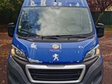 a blue van that is parked in a parking lot