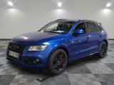 the blue audi suv is parked on a checkered tile floor