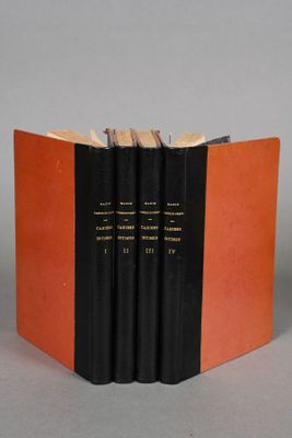 the three books are stacked on top of each other on a gray surface