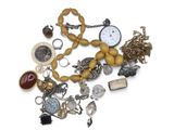 a pile of assorted jewelry on a white surface