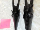 two black horns on a white table with a pink sticker