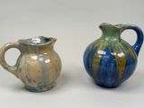 two vases sitting next to each other on a table