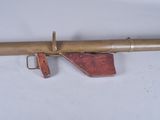 an old wooden rifle with a wooden barrel attached to it ' s side
