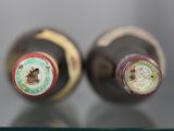 two bottles of wine sitting on a glass table
