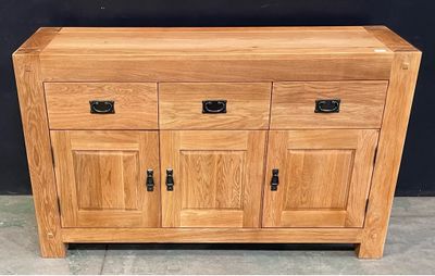 an image of a wooden cabinet with drawers and doors