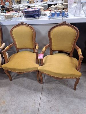 three yellow chairs sitting next to each other in front of a table