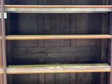 a wooden bookcase with many shelves in it