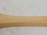 a close up of a wooden paddle with a chain around it
