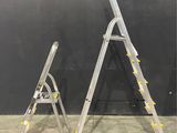 two ladders are standing next to each other in a room