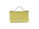a yellow handbag with a metal handle on a white background