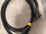 a picture of a black and yellow hose on a tiled floor
