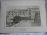 an old picture of a large building with a clock on it