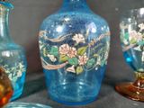three vases and two glasses sitting on a table