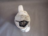 a white vase with a black and white design on it