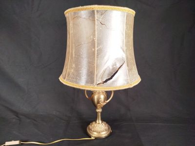 a lamp that is sitting on a table with a black background