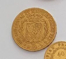three different types of gold coins on a white surface