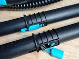 two black and blue hoses sitting on a wooden table