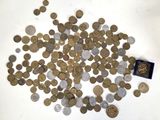 a pile of coins on a table with a small coin in the middle