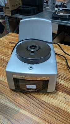 a silver and black stove top on a wooden table