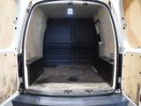 a white van with the door open in a garage