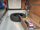 a box with a tire in the back of a truck