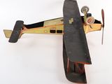 an old model of a small airplane on a white surface