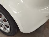 a close up of a car ' s front bumper and tire
