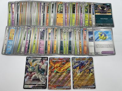 a lot of different pokemon cards on the table