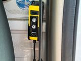 a yellow phone attached to the side of a car door